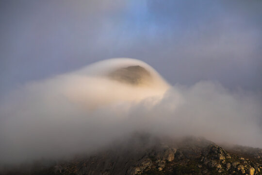 View of dramatic low cloud over Lion&rsquo;s Head Mountain close up, Saunder's Rock beach, Cape Town, South Africa.