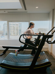 Athletic Girl Running on Treadmill in the Gym