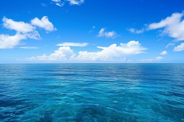 A photograph of a body of water with clouds hovering in the sky above, An endless blue ocean under a clear day sky, AI Generated