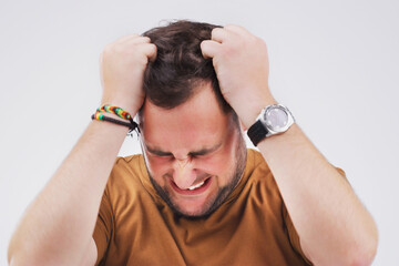 Man, frustrated and pulling hair in studio for burnout, stress and mental health. Male person,...