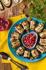 Delicious appetizer of grilled eggplants. Wrapped in rolls with nut paste. Served with pomegranates. - 788206847