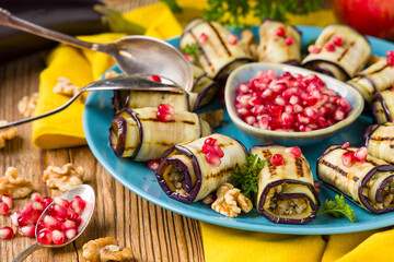 Delicious appetizer of grilled eggplants. Wrapped in rolls with nut paste. Served with pomegranates. - 788207286