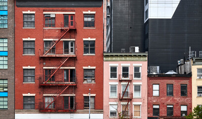 Old tenement houses with fire escapes in New York.