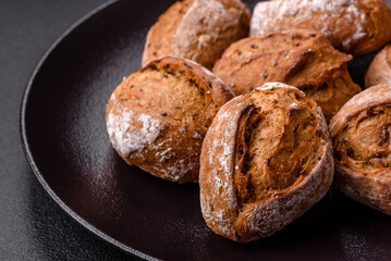 Fresh baked bread buns with salt, spices, seeds and grains