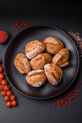 Fresh baked bread buns with salt, spices, seeds and grains