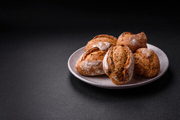Fresh baked bread buns with salt, spices, seeds and grains