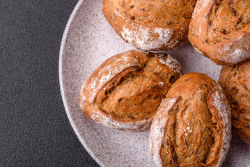 Fresh baked bread buns with salt, spices, seeds and grains
