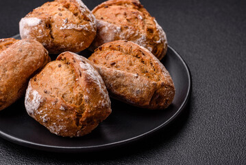 Fresh baked bread buns with salt, spices, seeds and grains