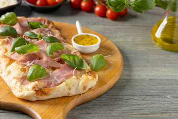 Traditional Roman pinsa with ham and basil. - 788209243
