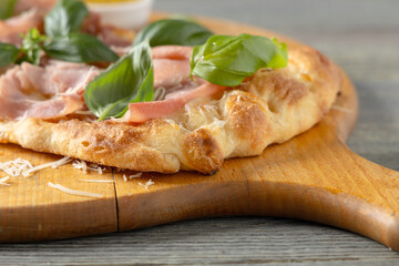 Traditional Roman pinsa with ham and basil. - 788209620