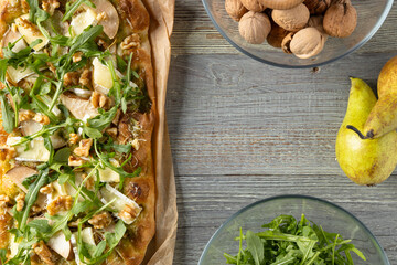Traditional Roman pinsa with pear, nuts and arugula