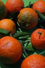 Fresh ripe mandarines with green leaves, selective focus