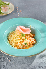Shrimp Risotto with Crispy Rice Chips Elegant Plating on Textured Backdrop