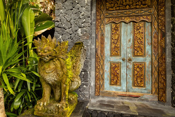 Bali style green wooden carved door in the traditional house of Ubud, Bali, Indonesia