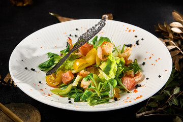 Gourmet Salmon and Shrimp Salad with Mixed Greens and Cherry Tomatoes on Elegant Dinner Table - 788215884