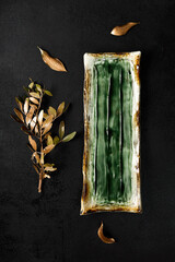 Gourmet Tart on Artisanal Ceramic Plate with Rustic Dried Leaves on Dark Background - 788216233
