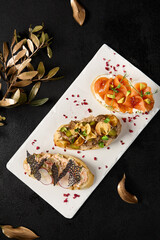 Assorted Bruschetta Platter Featuring Crab, Salmon with Avocado, and Roast Beef on Elegant Tableware - 788216429