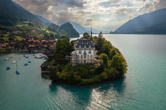 Iseltwald village on a peninsula in lake Brienz on a dramatic cloudy day in the alps in Canton Bern in Switzerland.