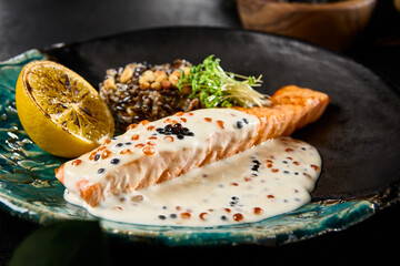 Gourmet Salmon Steak with Caviar Sauce and Brown Rice on Elegant Tableware - 788216835