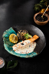 Elegant Dining Experience: Woman Enjoying Salmon Steak with Caviar Sauce and Brown Rice - 788216837