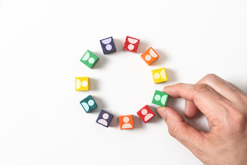 Circle of colorful wooden blocks representing unity of diverse elements or people.