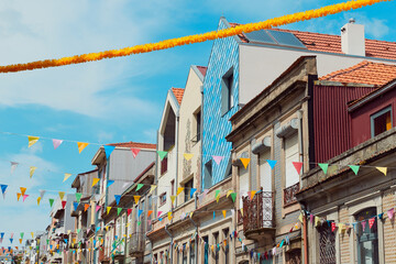 Festive bunting and lanterns decorate a narrow street for summer festival in June San Juan