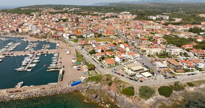 Aerial view of Portoscuso, an Italian municipality in the province of Southern Sardinia, Italy. The town, built on the sea, also has a small port that is very active in the summer season.