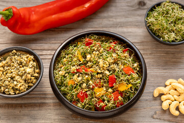 Alfalfa sprouts and roasted romano peppers salad. On the side, alfalfa sprouts and cashew nut...