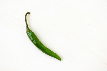 Fresh green hot chili pepper on a white background. Top view