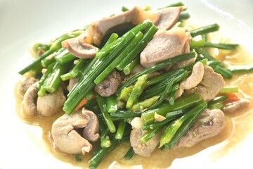 stir fried garlic chives with chicken organ on plate