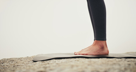 Person, feet and yoga on mat in outdoor for exercise, training and meditation or relax barefoot....