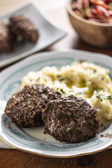 Minced meat cutlets with mashed potatoes topped with clarified butter. Traditional Slovak meatballs - Fasirky with potato puree. - 788236864