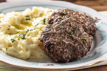 Minced meat cutlets with mashed potatoes topped with clarified butter. Traditional Slovak meatballs - Fasirky with potato puree. - 788237011