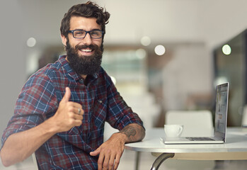 Man, thumbs up and laptop in creative workspace for online company, programming and coding for...
