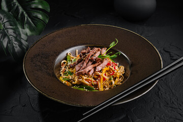 Gourmet asian beef stir fry on elegant plate