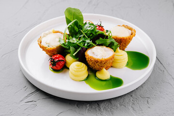 Gourmet goat cheese salad on white plate