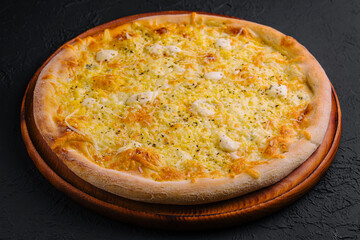 Fresh baked cheese pizza on wooden board