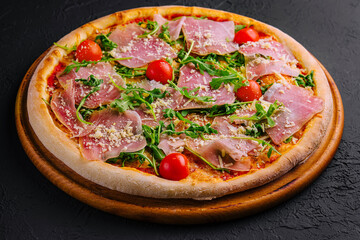 Gourmet italian pizza with prosciutto and arugula