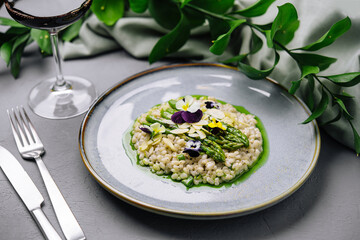 Gourmet risotto with asparagus and edible flowers