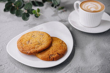 Freshly baked cookies with latte on table