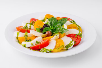 Fresh caprese salad with pesto sauce