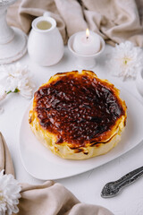 Homemade basque burnt cheesecake on elegant table setting