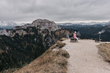 Solitude and Serenity: Girl on Mountain Path with Telescope in Central European Landscape - obrazy, fototapety, plakaty