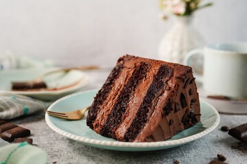 Homemade chocolate layer cake with mousse filling served on a plate, selective focus