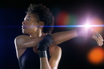 Black woman, arm and stretching as warm up workout on dark background or night, healthy or athlete. Female person, morning and exercise training for running marathon or mobility, studio or mockup