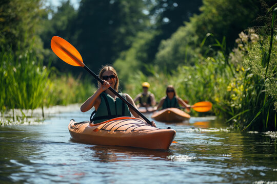 Group of adventurers in kayaks navigate a lush green canal on a sunny day