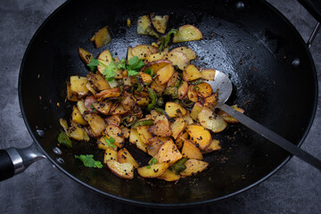 Fried potato in cast iron wok