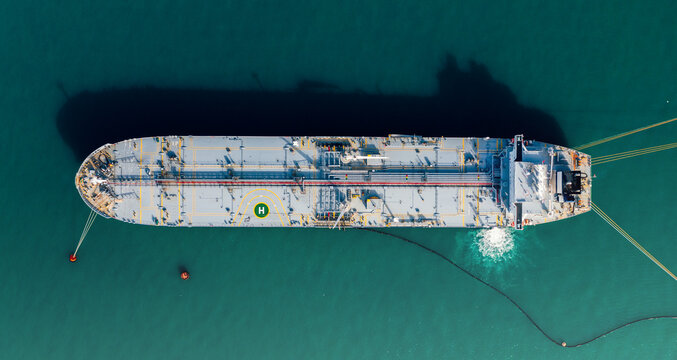 Oil tanker moored at sea, aerial top view. Global trading import and export logistic transportation.