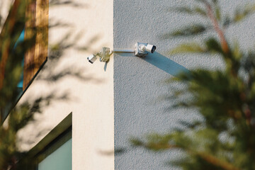 CCTV surveillance video. Two surveillance cameras placed on the exterior wall of the house to...