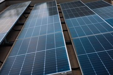 Green energy concept photo. Image with selective focus and camera movement. Solar panels on top of...